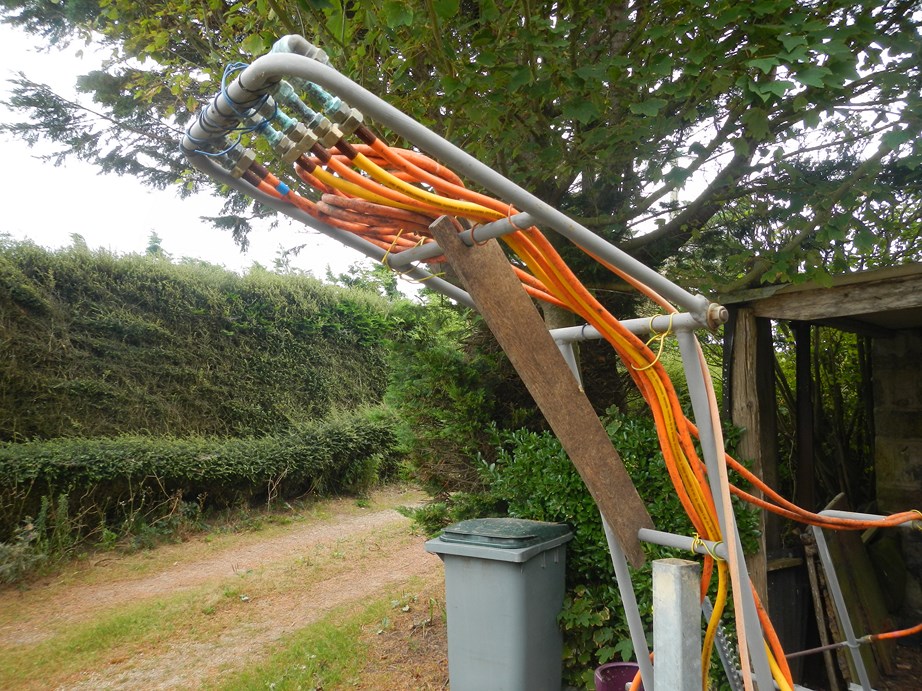 Bras de commande en position haute pour être accessible depuis le tracteur (maintenu pas une cale en bois)