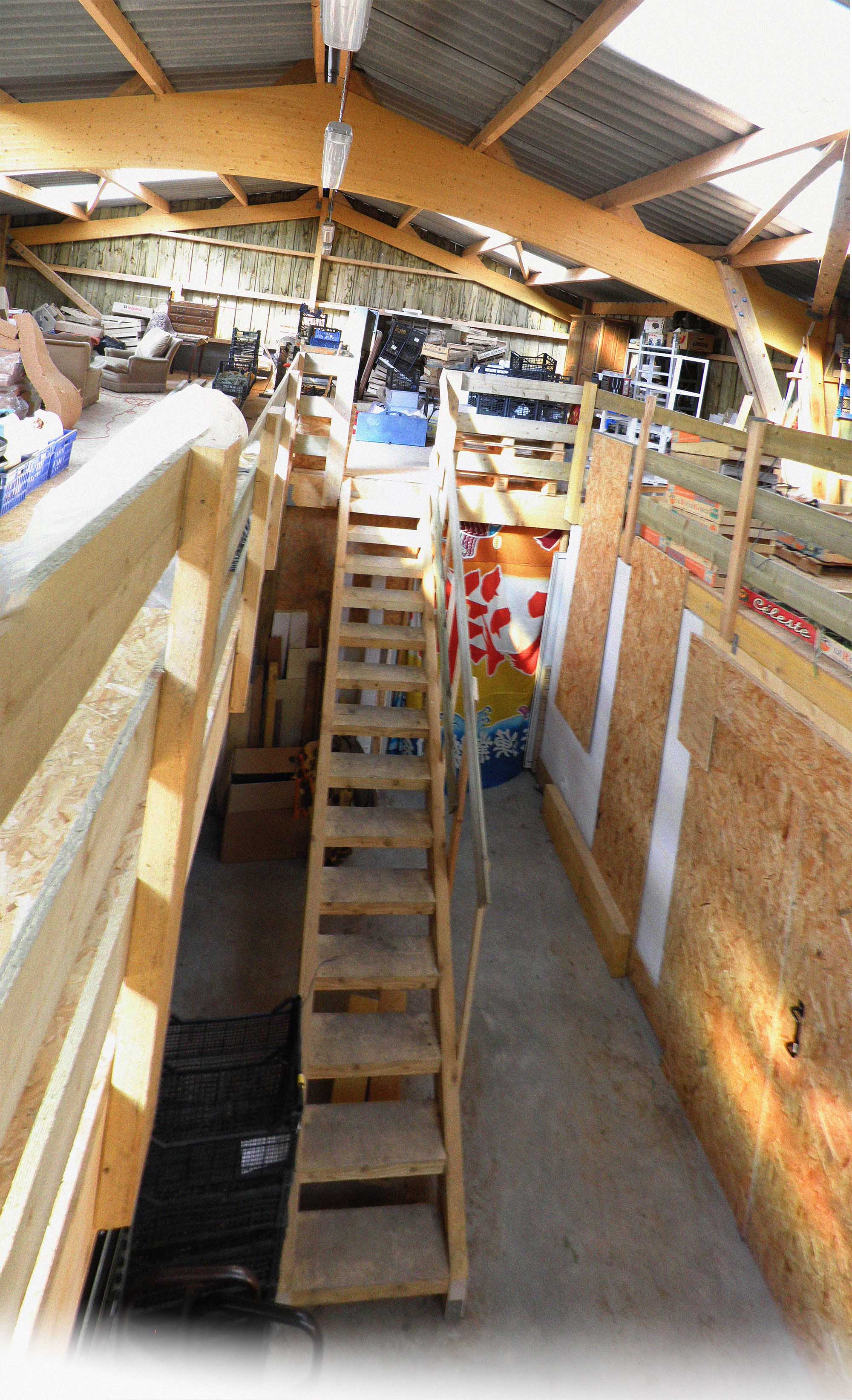 Vue sur l'escalier intérieur. Au fond, l'accès à la salle conviviale. Sur la droite, la salle de stockage chaud et de germination.